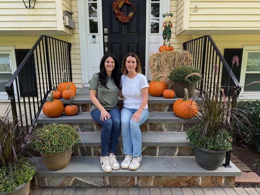 The Polished Porch owners on a decorated fall porch